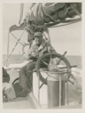 Image of Dr. Bailey at the wheel of the Bowdoin